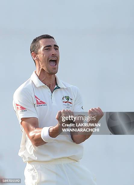 Australia's Mitchell Starc celebrates after he dismissed Sri Lanka's Dilruwan Perera during the third day of the third and final Test cricket match...