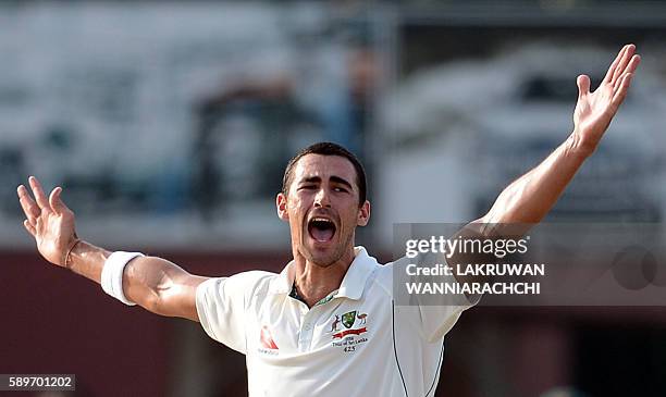 Australia's Mitchell Starc celebrates after he dismissed Sri Lanka's Dilruwan Perera during the third day of the third and final Test cricket match...