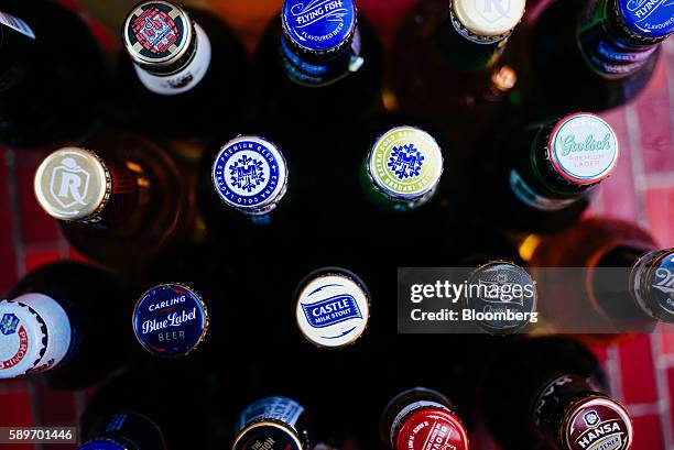 Bottles of SABMiller Plc beer brands including Castle, Carling Blue Label, Hansa Pilsener, Milk Stout, Perroni Nastro Azzurro, Flying Fish and Redd's...