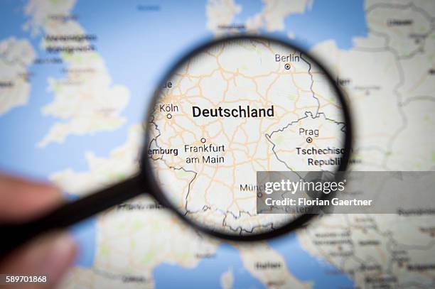 In this photo illustration to the topic 'Germany' the country is seen on a map through a lens on August 08, 2016 in Melaune, Germany.