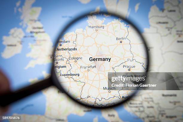 In this photo illustration to the topic 'Germany' the country is seen on a map through a lens on August 08, 2016 in Melaune, Germany.