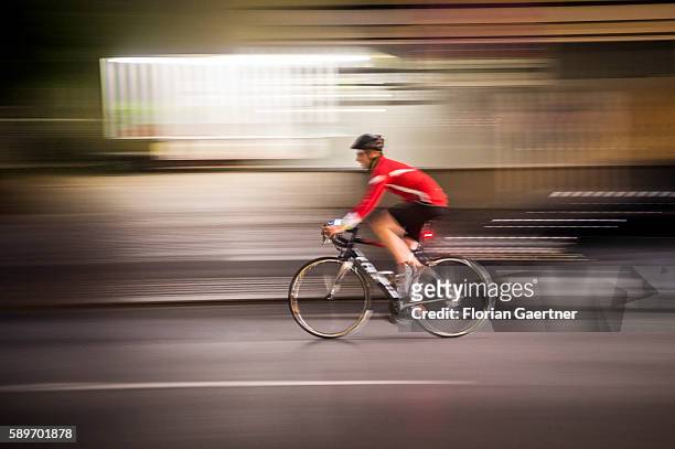 Man rides with his bicycle at night on August 09, 2016 in Berlin, Germany.