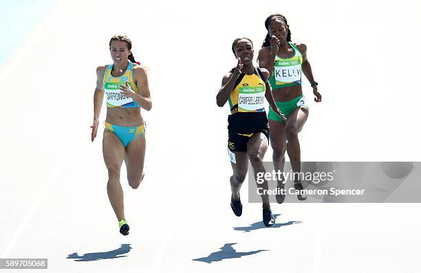 Olga Safronova of Kazakhstan, Veronica Campbell-Brown of Jamaica and Ashley Kelly of Virgin Islands, British compete in round one of the Women's 200m...