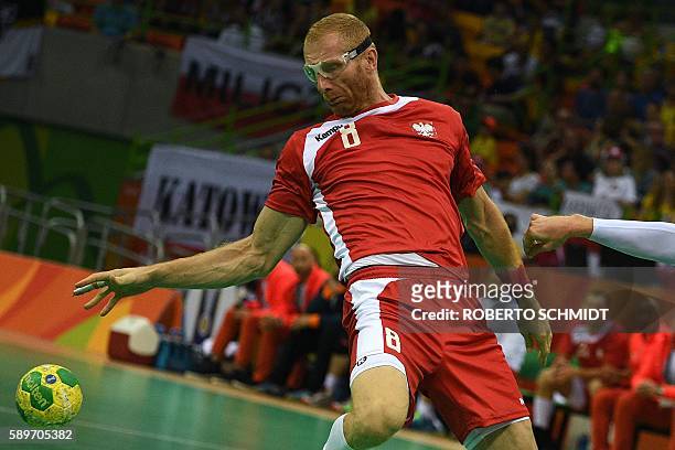 Poland's left back Karol Bielecki bounces the ball during the men's preliminaries Group B handball match Poland vs Slovenia for the Rio 2016 Olympics...