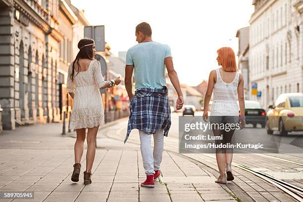 young people in hippie style fashion walking on sidewalk - osijek - fotografias e filmes do acervo