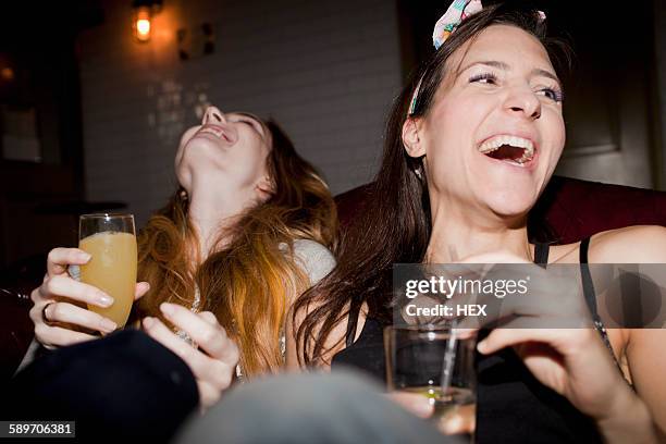 happy young friends enjoying drinks at a bar - ladies night stock pictures, royalty-free photos & images