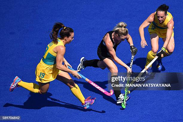 Australia's Georgie Parker and Australia's Madonna Blyth vies with New Zealand's Anita McLaren during the the women's quarterfinal field hockey New...