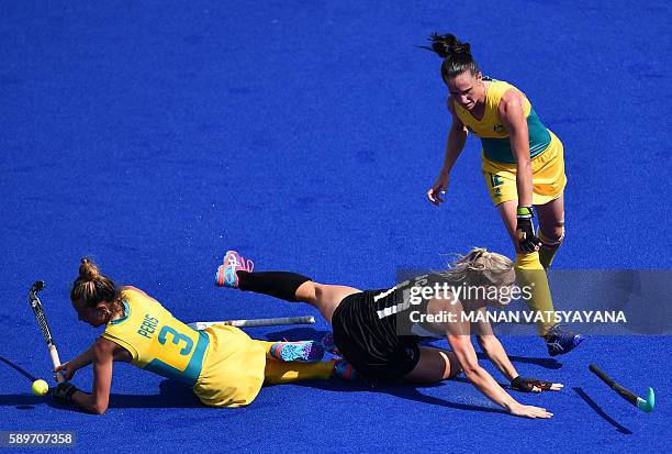 Australia's Brooke Peris and Australia's Madonna Blyth vie with New Zealand's Sophie Cocks during the the women's quarterfinal field hockey New...