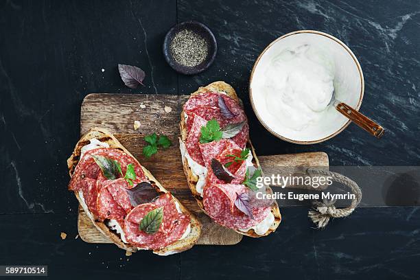 white bean, horseradish and salami bruschetta - salami stock pictures, royalty-free photos & images