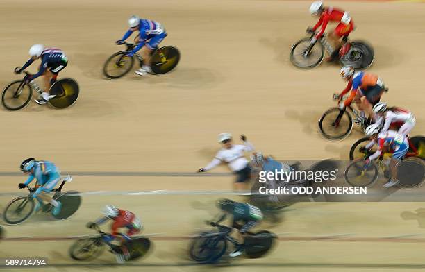 Canada's Allison Beveridge and Germany's Anna Knauer fall during the Women's Omnium Scratch race track cycling event at the Velodrome during the Rio...