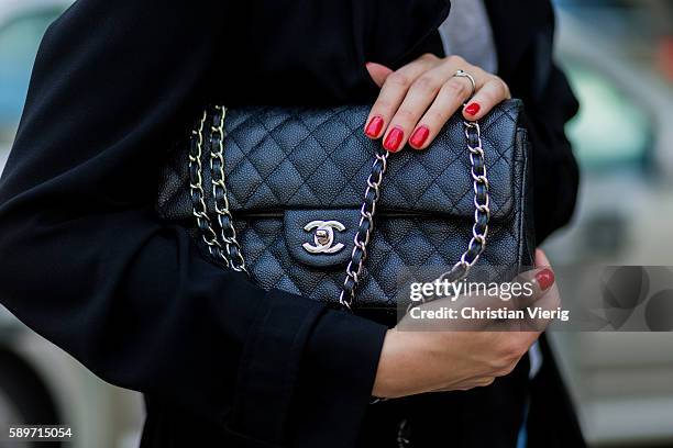 Maxilie Mlinarskij wearing a black Chanel bag and red nail polish on August 15, 2016 in Berlin, Germany.