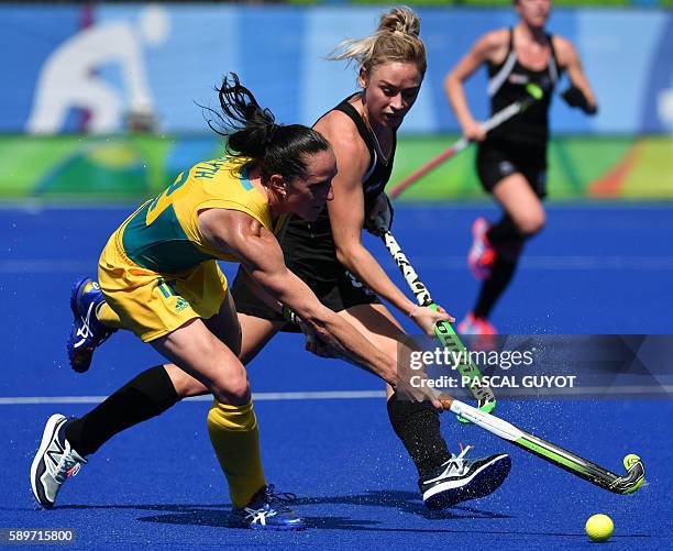 Australia's Madonna Blyth vies with New Zealand's Anita McLaren during the women's quarterfinal field hockey New Zealand vs Australia match of the...