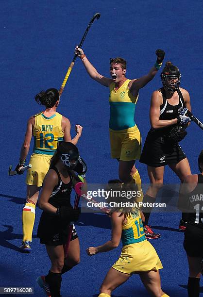 Kathryn Slattery of Australia celebrates with Madonna Blyth after scoring against New Zealand during the quarter final hockey game on Day 10 of the...
