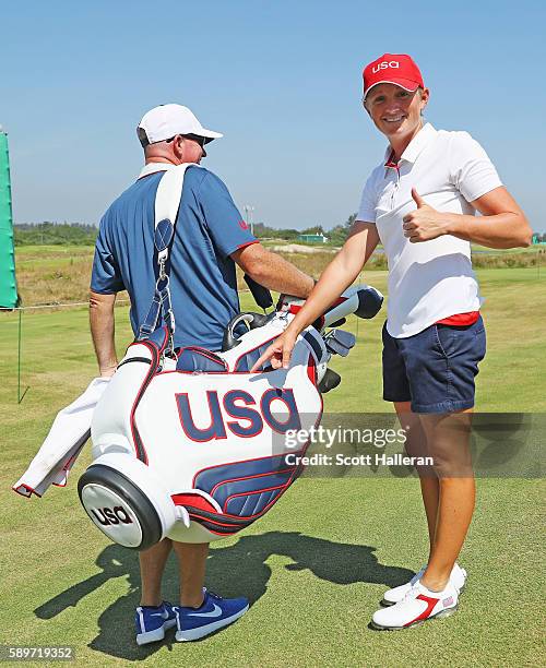 Stacy Lewis of the United States poses with her caddie Travis Wilson during a practice round prior to the start of the women's golf during Day 10 of...