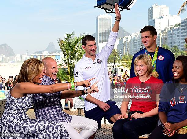 Michael Phelps reacts to a question from Matt Lauer as Hoda Kotb, Katie Ledecky, Nathan Adrian and Simone Manuel laugh on the Today show set on...