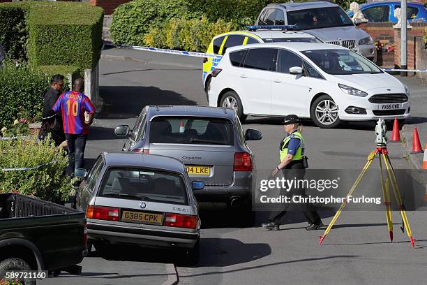 Police officers work in Meadow Way, Trench, Telford at the scene where former Aston Villa player Dalian Atkinson was tasered by police on August 15,...