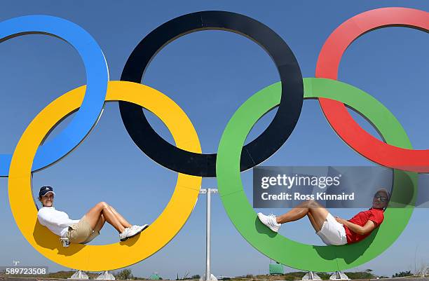 Azahara Munoz of Spain and Carlota Ciganda of Spain posr in the Olympic rings during a practice round prior to the Women's Individual Stroke Play...