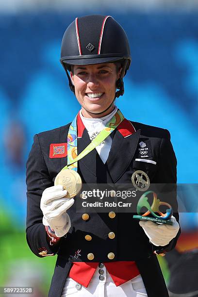 Gold medalist, Charlotte Dujardin of Great Britain riding Valegro celebrates on the podium during the medal ceremony during the Dressage Individual...