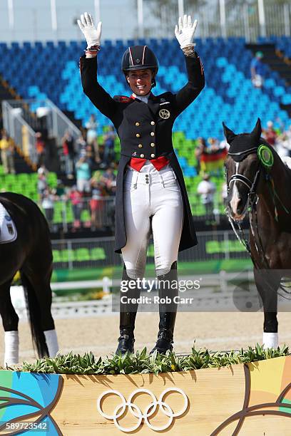 Gold medalist, Charlotte Dujardin of Great Britain riding Valegro celebrates on the podium during the medal ceremony during the Dressage Individual...