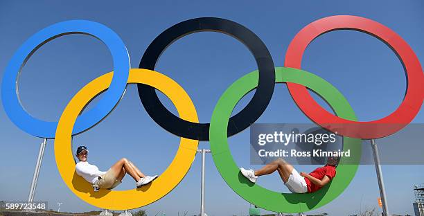 Azahara Munoz of Spain and Carlota Ciganda of Spain posr in the Olympic rings during a practice round prior to the Women's Individual Stroke Play...