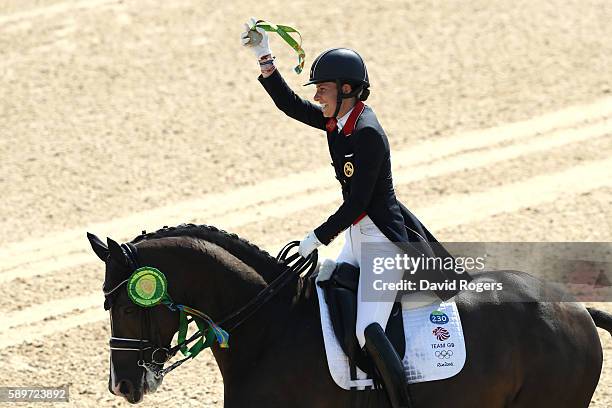 Gold medalist, Charlotte Dujardin of Great Britain riding Valegro celebrates during the medal ceremony after winning the Dressage Individual Grand...