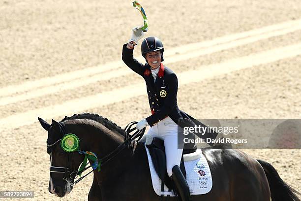 Gold medalist, Charlotte Dujardin of Great Britain riding Valegro celebrates during the medal ceremony after winning the Dressage Individual Grand...