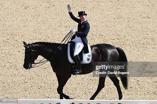 Silver medalist, Isabell Werth of Germany riding Weihegold Old celebrates during Dressage Individual Grand Prix Freestyle on Day 10 of the Rio 2016...