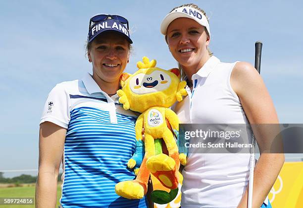 Ursula Wikstrom and Noora Tamminen of Finland pose together during a practice round prior to the start of the women's golf during Day 10 of the Rio...