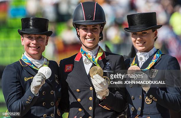 Britain's Charlotte Dujardin , Germany's Isabell Werth and Germany's Kristina Broring-Sprehe show their gold, silver and bronze medals respectively...