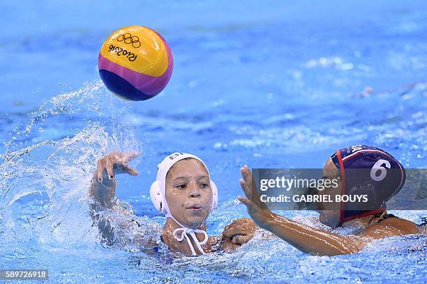 Brazil's Izabella Chiappini passes the ball in front of USA Maggie Steffens during their Rio 2016 Olympic Games waterpolo quaterfinal match at the...