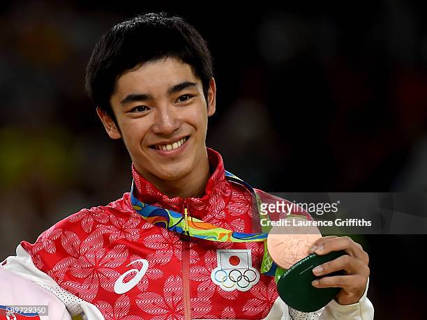 Bronze medalist Kenzo Shirai of Japan poses for photographs on the podium at the medal ceremony for Men's Vault on day 10 of the Rio 2016 Olympic...