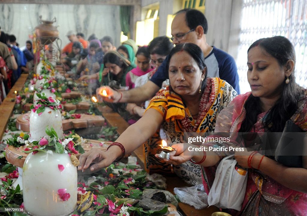 Devotee performing Abhishek at a Lord Shiva Temple on the...