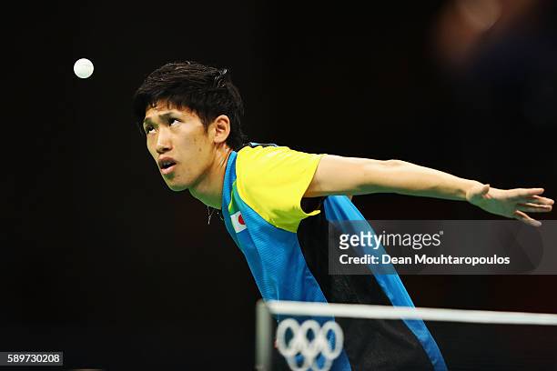 Maharu Yoshimura of Japan keeps his eye on the ball against Dimitrij Ovtcharov of Germany during Mens Team Semifinal on Day 10 of the Rio 2016...