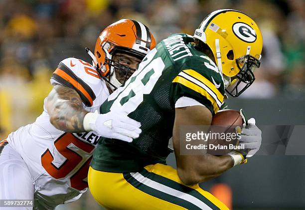 Scooby Wright III of the Cleveland Browns tackles John Crockett of the Green Bay Packers in the third quarter at Lambeau Field on August 12, 2016 in...
