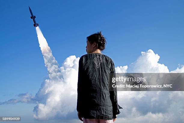 portrait of a woman against rocket launch - cloud burst stock pictures, royalty-free photos & images