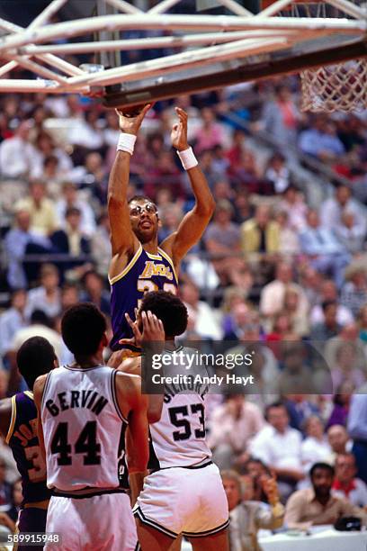 Kareem Abdul-Jabbar of the Los Angeles Lakers shoots the ball against Artis Gilmore of the San Antonio Spurs during a game circa 1986 at HemisFair...