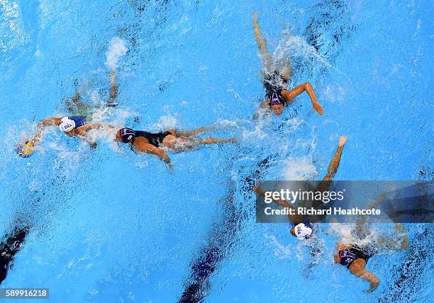 Amanda Oliveira of Brazil holds off Kiley Neushul of USA in the Brazil v USA Women's water Polo Quarter Final at Olympic Aquatics Stadium on August...