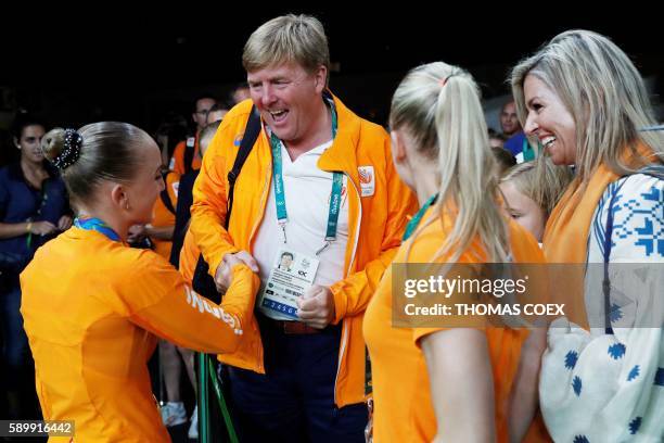 King Willem-Alexander and Queen Maxima (R0 congratulate Netherlands' Sanne Wevers on winning the women's balance beam event final of the Artistic...