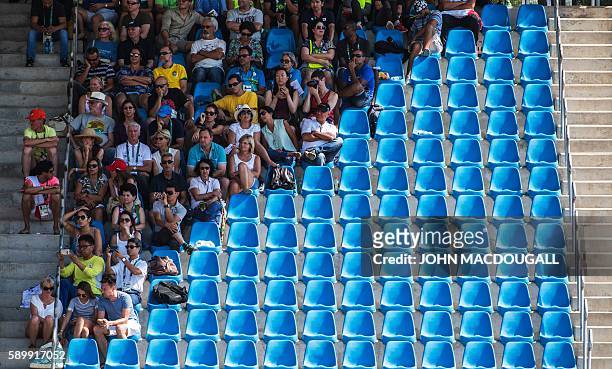 Spectators stay out of the sun during the Equestrian's Dressage Grand Prix Freestyle event of the Rio 2016 Olympic Games at the Olympic Equestrian...