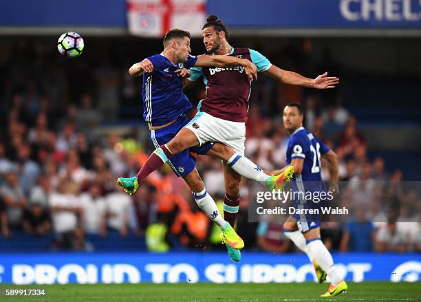 Gary Cahill of Chelsea jumps for a header with Andy Carroll of West Ham United during the Premier League match between Chelsea and West Ham United at...
