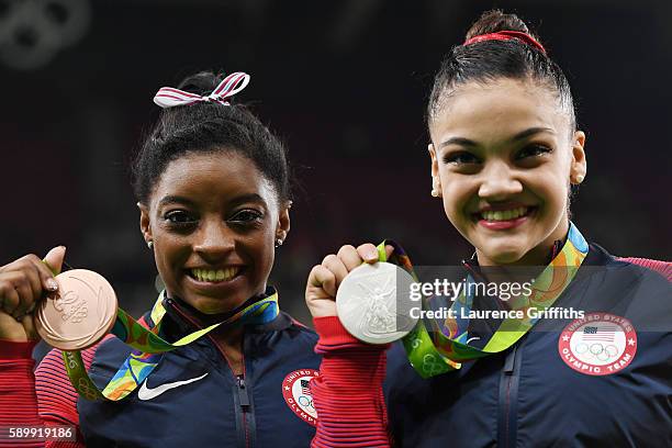 Bronze medalist Simone Biles and silver medalist Lauren Hernandez of the United States pose for photographs after the at the medal ceremony for the...