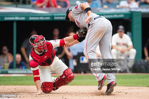 Catcher Chris Gimenez of the Cleveland Indians tags out Travis Shaw of the Boston Red Sox at home to end the top of the third inning at Progressive...