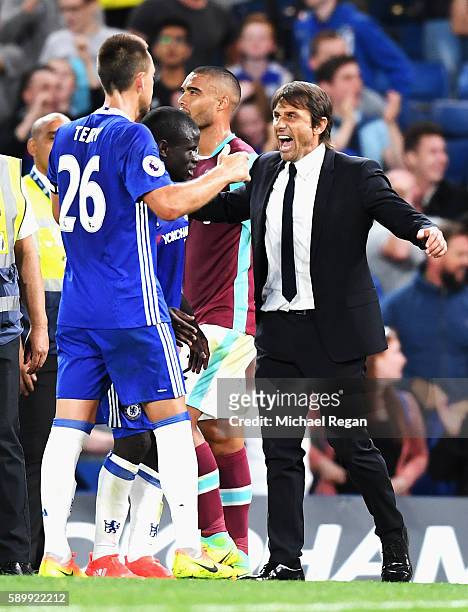 Antonio Conte, Manager of Chelsea celebrates victory with John Terry of Chelsea after the Premier League match between Chelsea and West Ham United at...