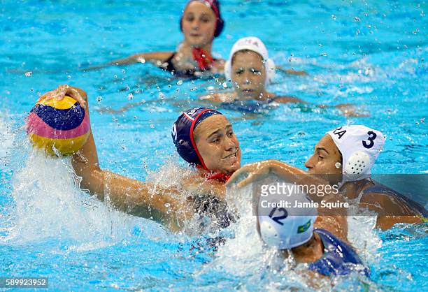 Aria Fischer of United States shoots as Marina Zablith and Gabriela Mantellato of Brazil defend during their Women's Water Polo quarterfinal match at...