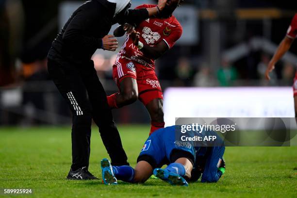 Ostersund's goalkeeper Aly Keita remains on the ground after a masked soccer spectator attacked him during a football match between Jonkoping Sodra...