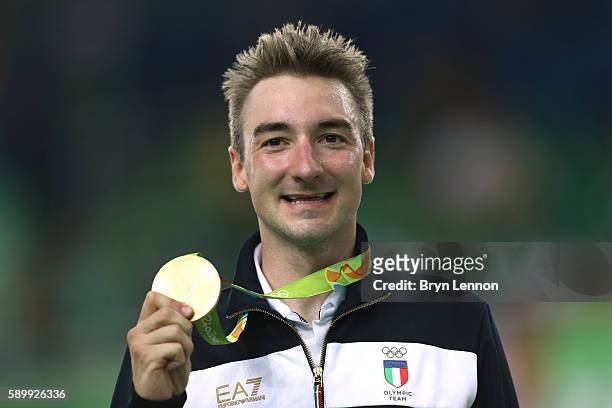 Gold medalist Elia Viviani of Italy celebrates on the podium during the medal ceremony for the Cycling Track Men's Omnium Points Race 6\6 on Day 10...