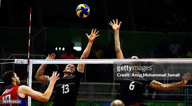 Seyed Mohammad Mousavi Eraghi and Mehdi Mahdavi in action during the men's qualifying volleyball match between Russia and Iran on Day 10 of the Rio...