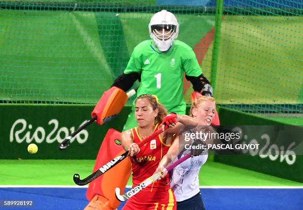 Spain's Cristina Guinea vies with Britain's Nicola White during the women's quarterfinal field hockey Britain vs Spain match of the Rio 2016 Olympics...