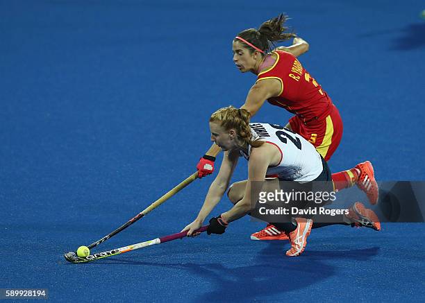 Nicola White of Great Britain stretches for the ball as Rocio Ybarra challenges during the Women's quarter final hockey match between Great Britain...