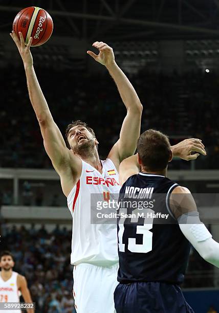 Pau Gasol of Spain shoots against Andres Nocioni of Argentina during a Men's Basketball Preliminary Round Group B game between Spain and Argentina on...